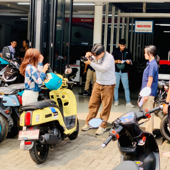 People taking photos of scooters